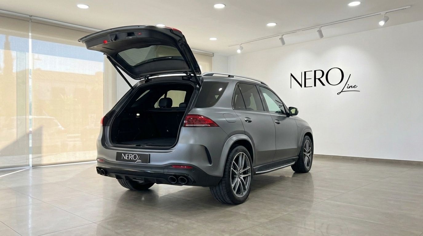 The matte Selenite Grey Magno Mercedes-Benz GLE AMG Line with its boot open, parked in a showroom in Mallorca.