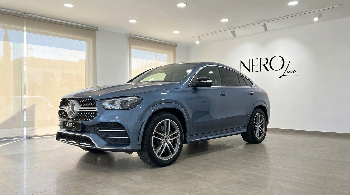 Mercedes-Benz GLE Coupe — Showroom in Mallorca The 2022 Mercedes-Benz GLE Coupe in metallic steel blue, shown from a front three-quarter angle in a showroom in Mallorca.