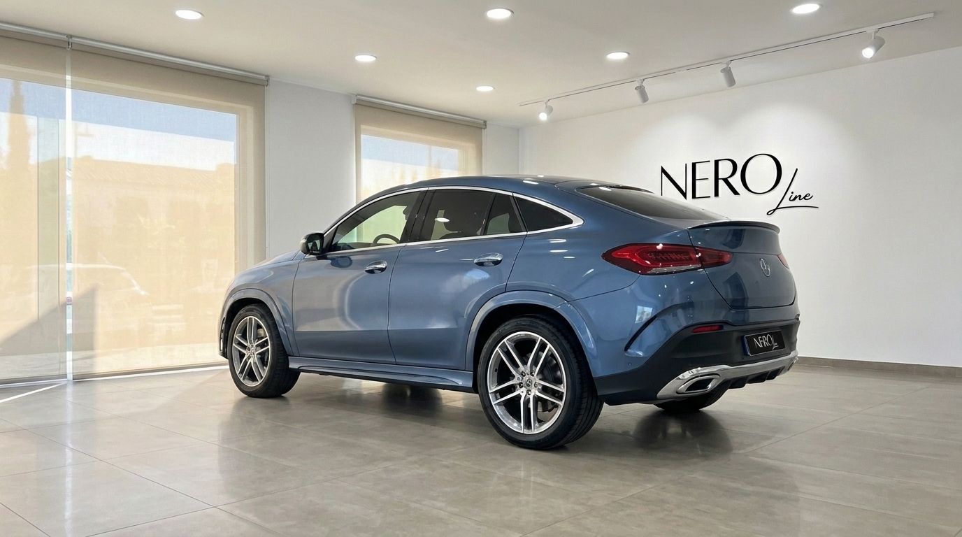 The 2022 Mercedes-Benz GLE Coupe in metallic steel blue, shown from a rear three-quarter angle in a showroom in Mallorca.