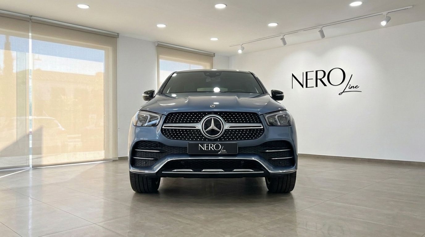 A metallic steel blue Mercedes-Benz GLE Coupe 2022 is shown from the front in a bright showroom in Mallorca.