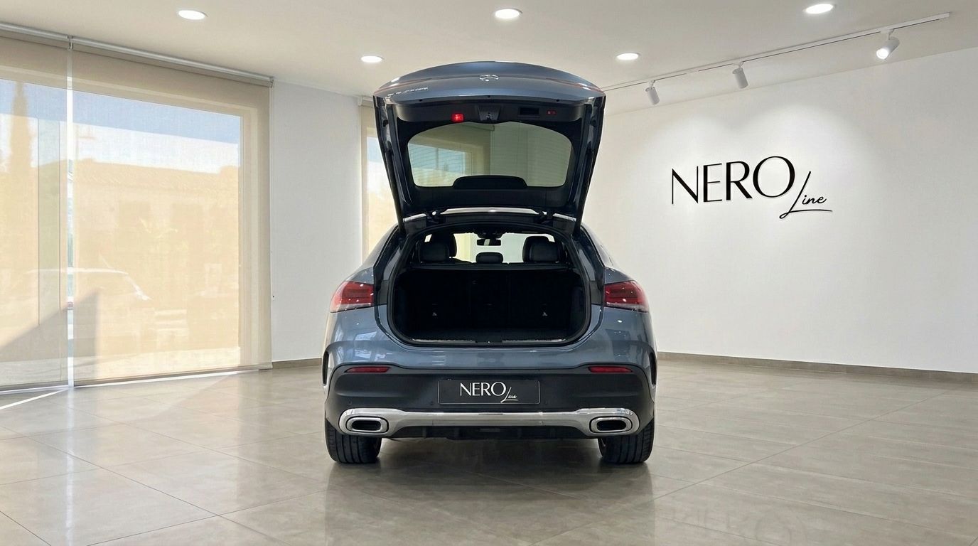 The Mercedes-Benz GLE Coupe 2022 in Metallic Steel Blue Metallic, showcasing its open trunk and spacious cargo area in a Mallorca showroom.