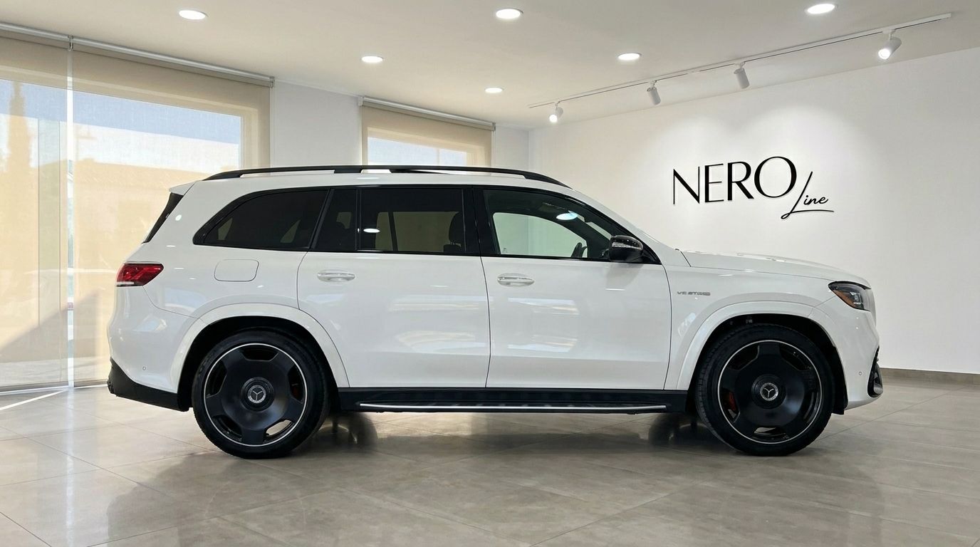 The white Mercedes-Benz GLS 63 AMG is seen from its side profile in a showroom in Alicante.