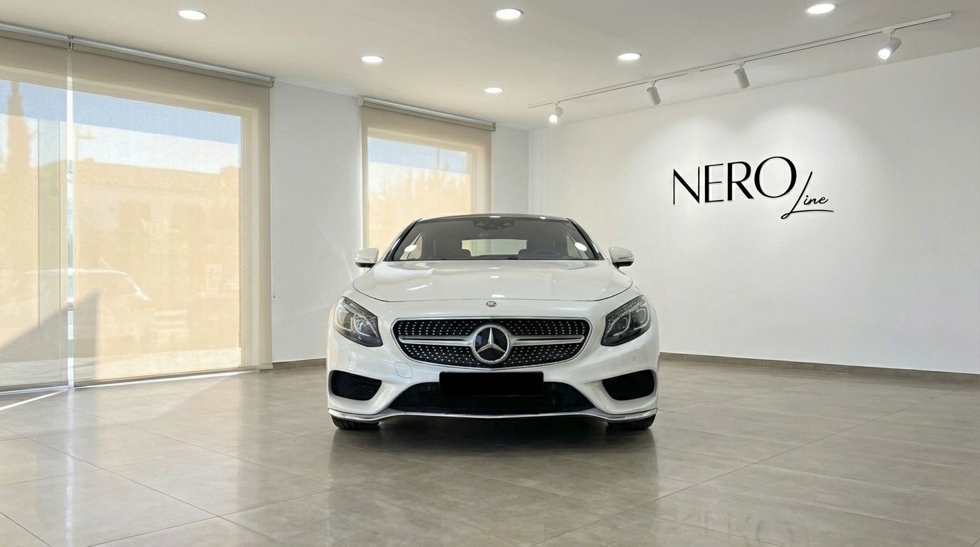 The white 2019 Mercedes-Benz S500 Coupe is shown from the front, parked on a tiled floor in a bright showroom in Alicante.