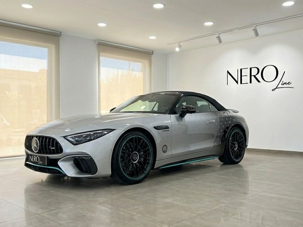 Mercedes-Benz SL43 AMG — Showroom view The silver 2023 Mercedes-Benz SL43 AMG convertible, with its black soft top, is elegantly displayed in a bright Alicante showroom.
