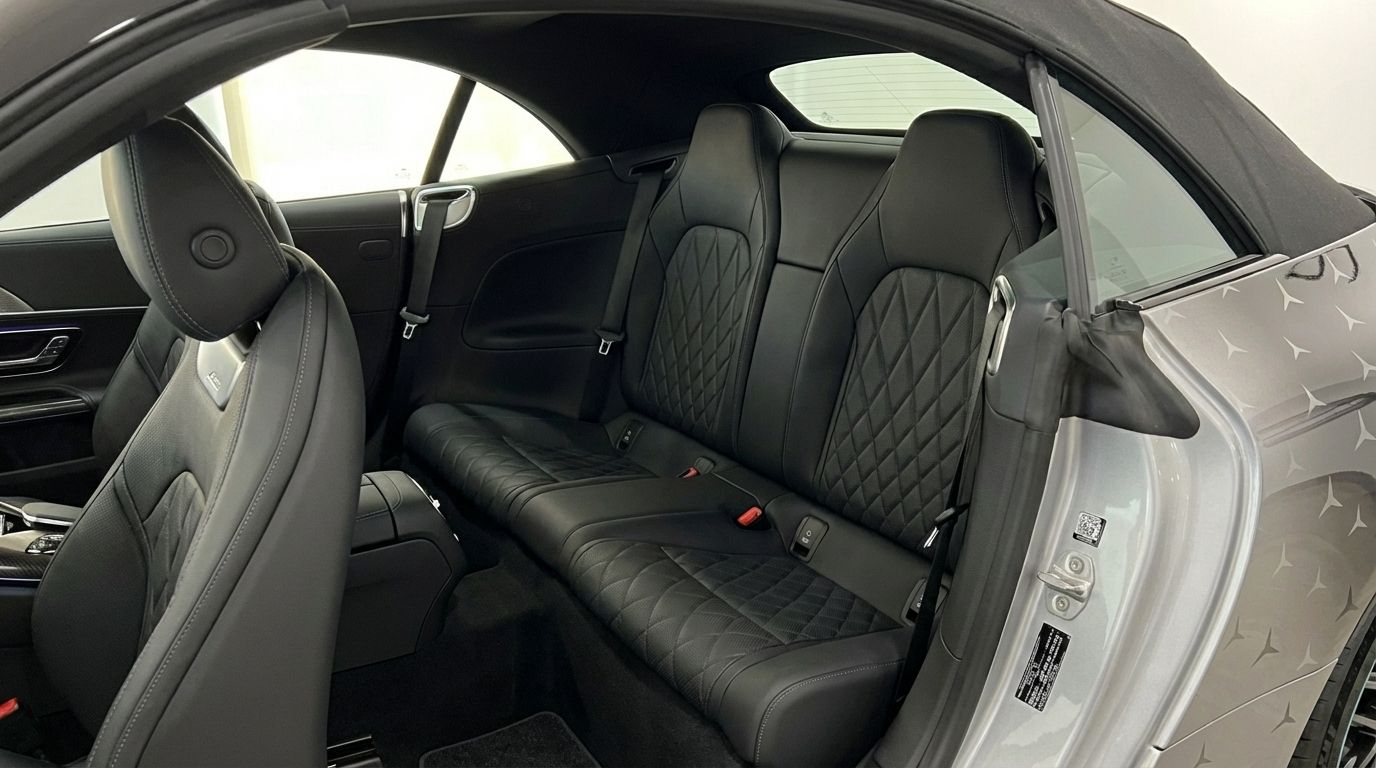 The luxurious black leather rear seats with diamond stitching of the Mercedes-Benz SL43 AMG are visible from the open door in Alicante.
