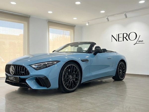 Mercedes-Benz SL63 AMG — Luxury Convertible in Showroom A baby blue Mercedes-Benz SL63 AMG convertible, with its top down, is elegantly displayed in a showroom in Alicante.