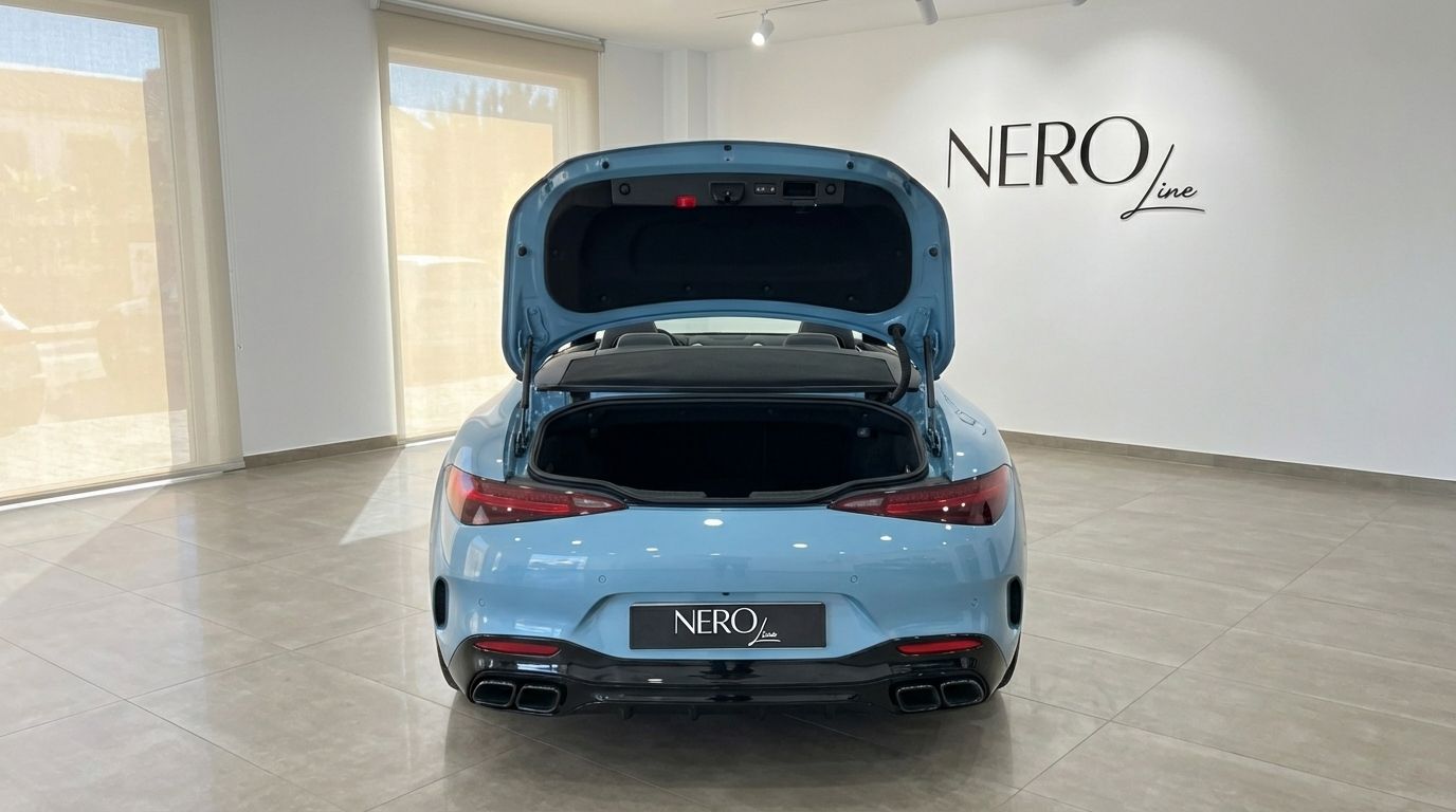 The baby blue Mercedes-Benz SL63 AMG is shown from the rear with its trunk open in a showroom in Alicante.