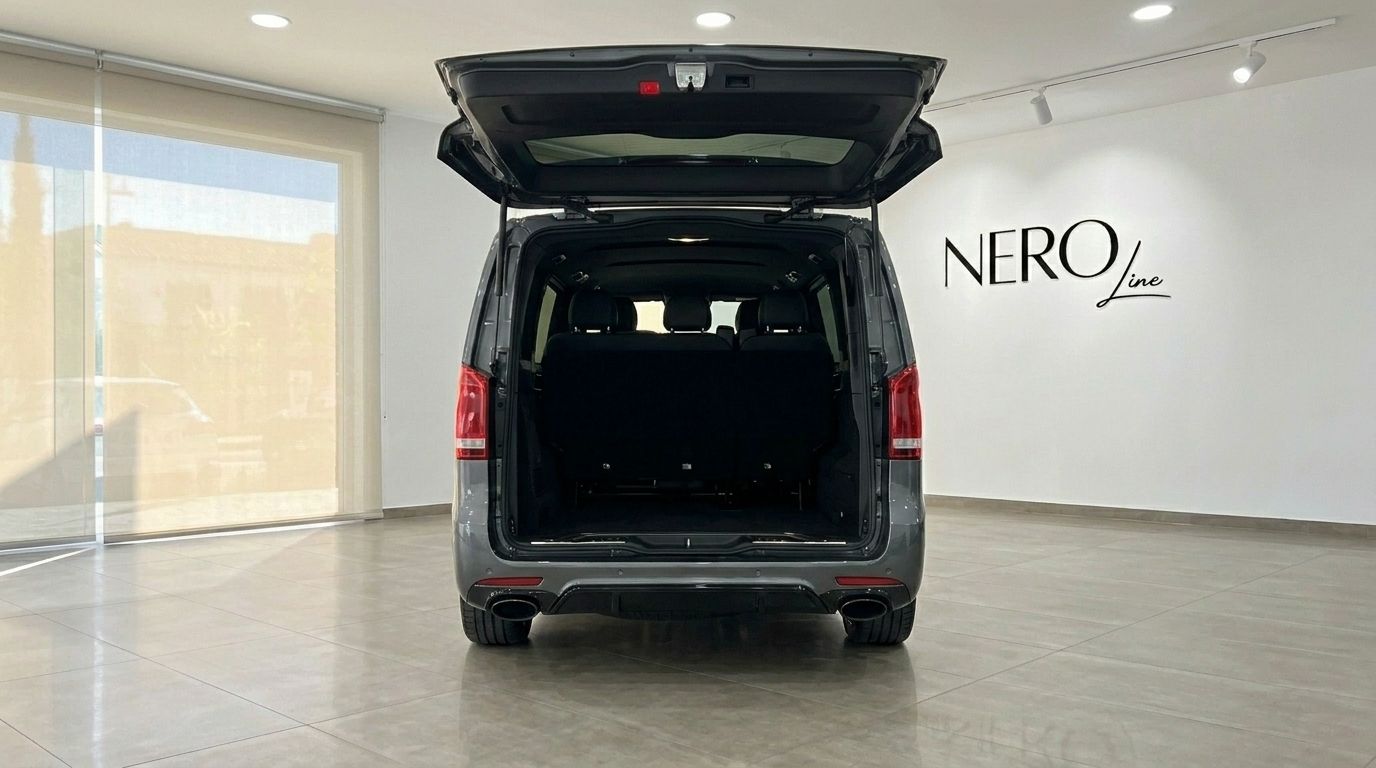 Rear view of the Mercedes-Benz V-Class 250d in gloss metallic Daytona Gray, with its trunk open, showcasing the spacious interior in Benidorm.