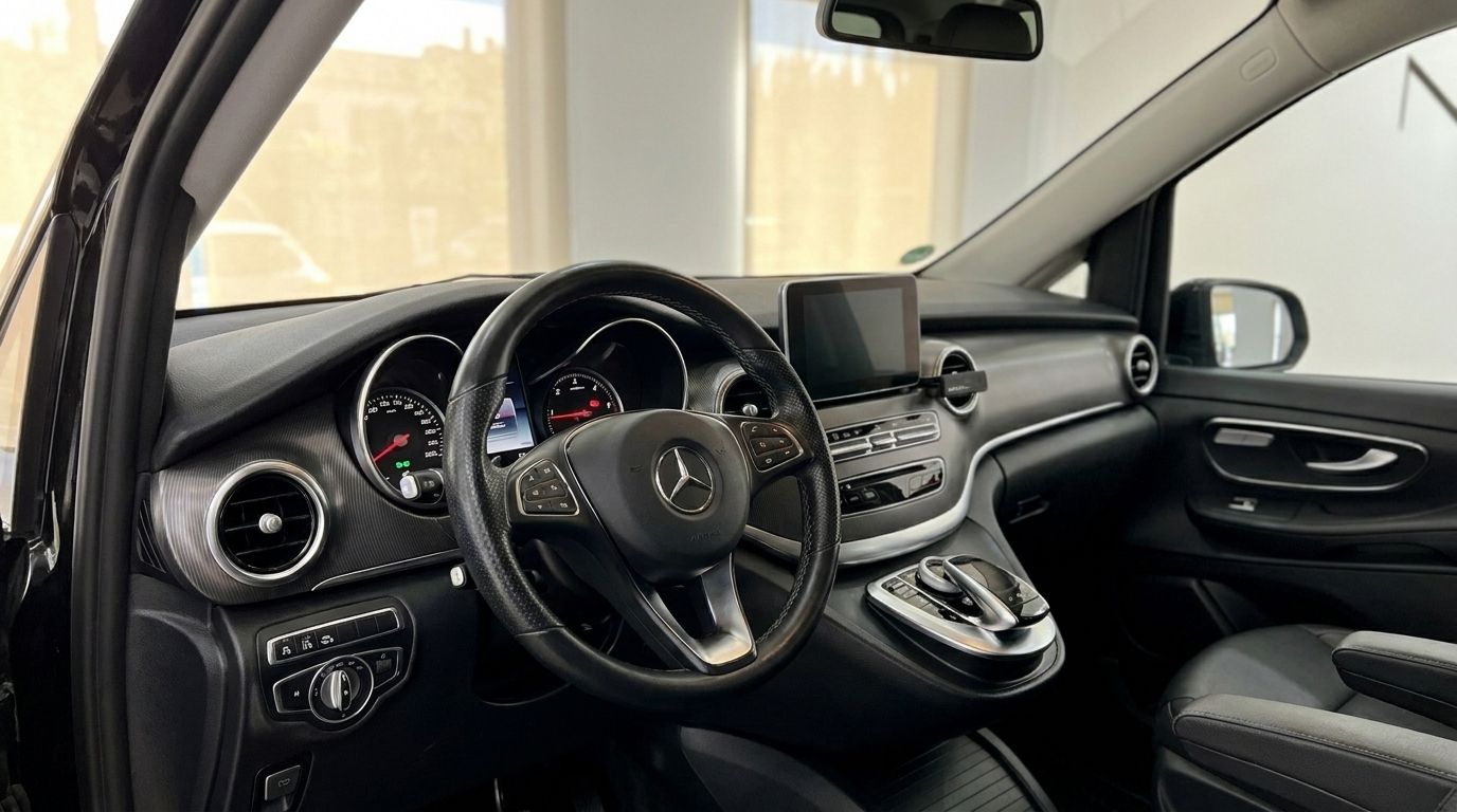The luxurious interior cockpit of the Mercedes-Benz V-Class 250d, featuring the steering wheel and dashboard, available for rental in Alicante.