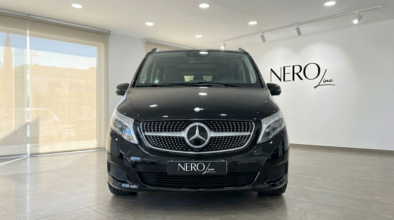 The front view of a black Mercedes-Benz V-Class 250d, showcasing its grille and headlights, parked indoors in Alicante.