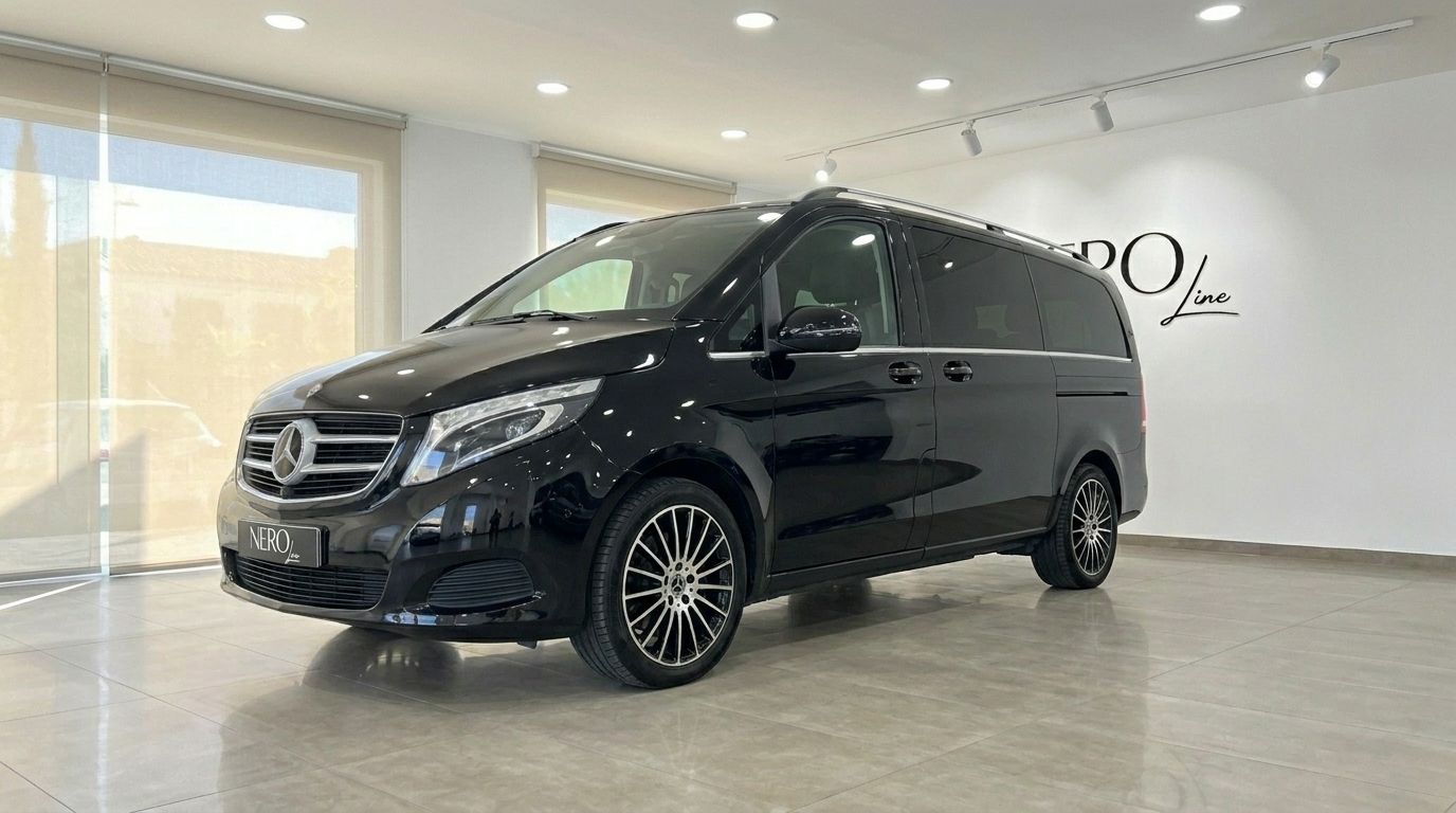 The black Mercedes-Benz V-Class 250d is parked in a showroom with large windows in Alicante.