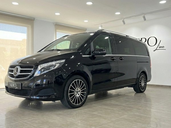 Mercedes-Benz V-Class 250d — Showroom view The black Mercedes-Benz V-Class 250d is parked in a showroom with large windows in Alicante.
