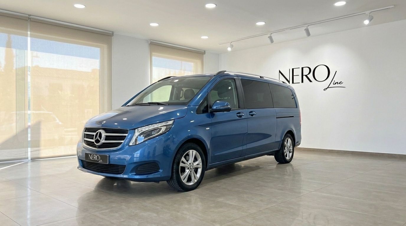 The metallic blue Mercedes-Benz V-Class 300d Extralang is parked indoors, showcasing its elegant front three-quarter view in Mallorca.