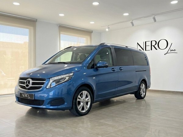 Mercedes-Benz V-Class 300d Extralang — Front view Mallorca The metallic blue Mercedes-Benz V-Class 300d Extralang is parked indoors, showcasing its elegant front three-quarter view in Mallorca.