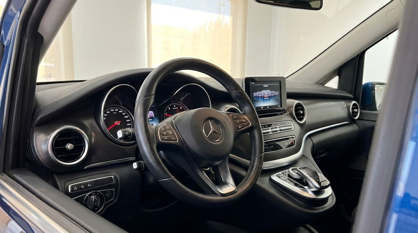 The luxurious interior of the Mercedes-Benz V-Class 300d Extralang in Mallorca, showing the dashboard and steering wheel.