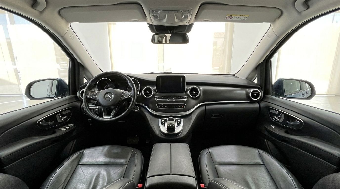The luxurious black interior of the Mercedes-Benz V-Class 300d Extralang, showing the dashboard and front seats in Mallorca.