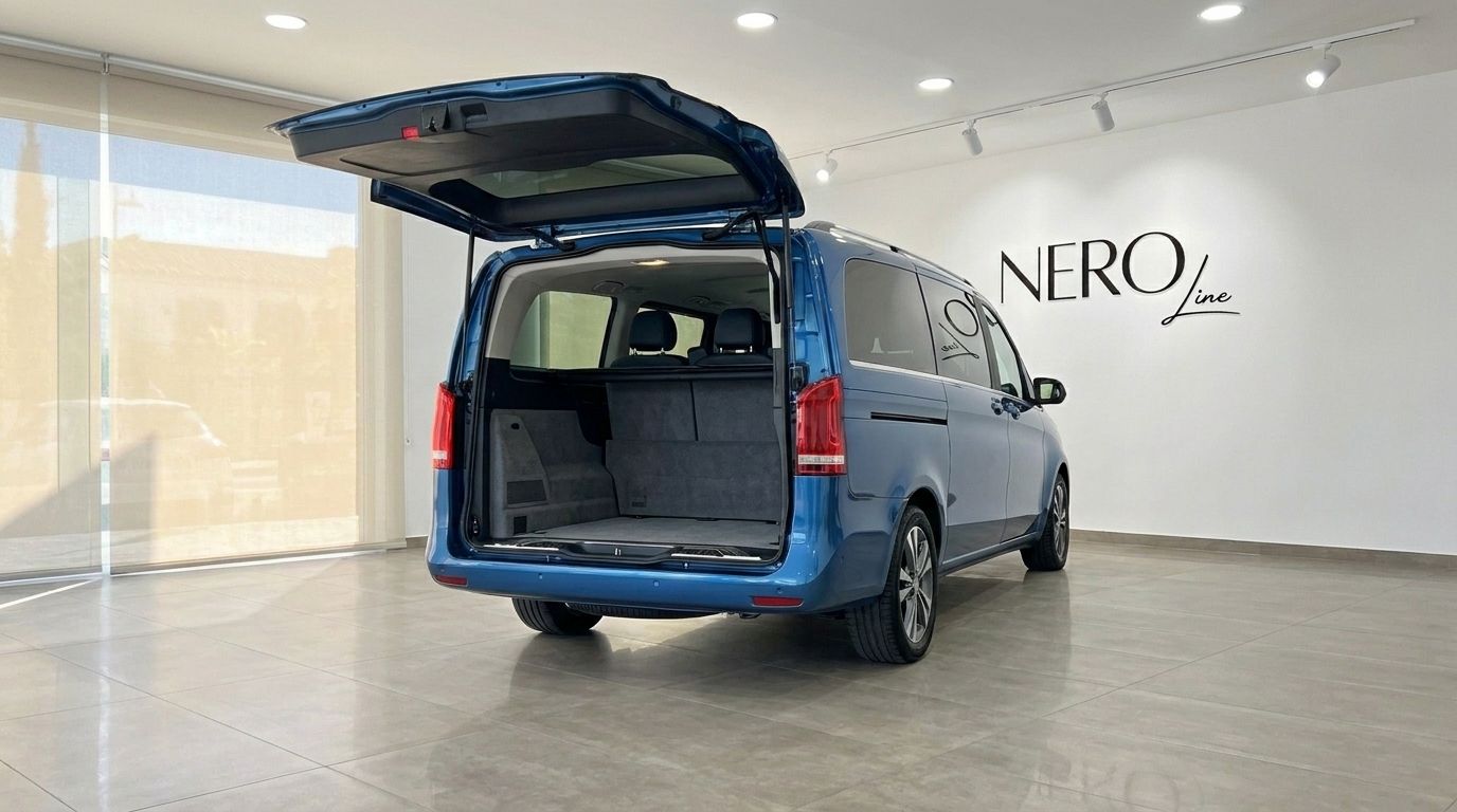 The metallic blue Mercedes-Benz V-Class 300d Extralang from 2017 with its open boot revealing the spacious cargo area, displayed in Mallorca.