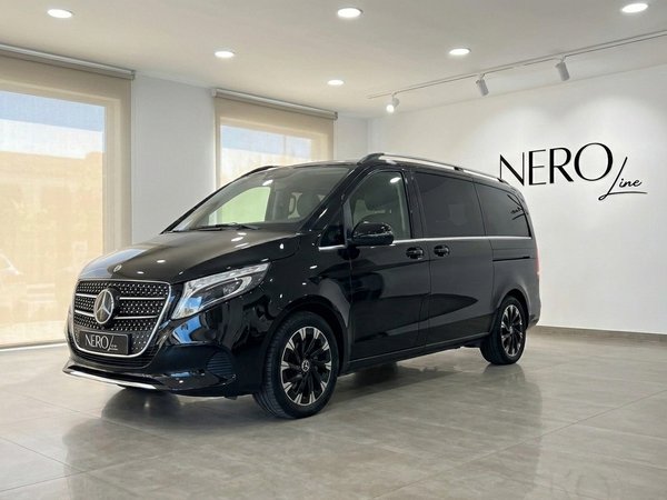 Mercedes-Benz V-Class — Luxury Minivan Ibiza A gloss black Mercedes-Benz V-Class (V220) minivan is parked in a showroom in Ibiza, showing its elegant front three-quarter view.