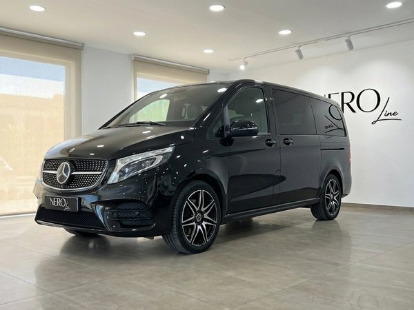 Mercedes-Benz V250d Avantgarde — Marbella showroom A sleek black Mercedes-Benz V250d Avantgarde luxury van is showcased from a front three-quarter view in a Marbella showroom.