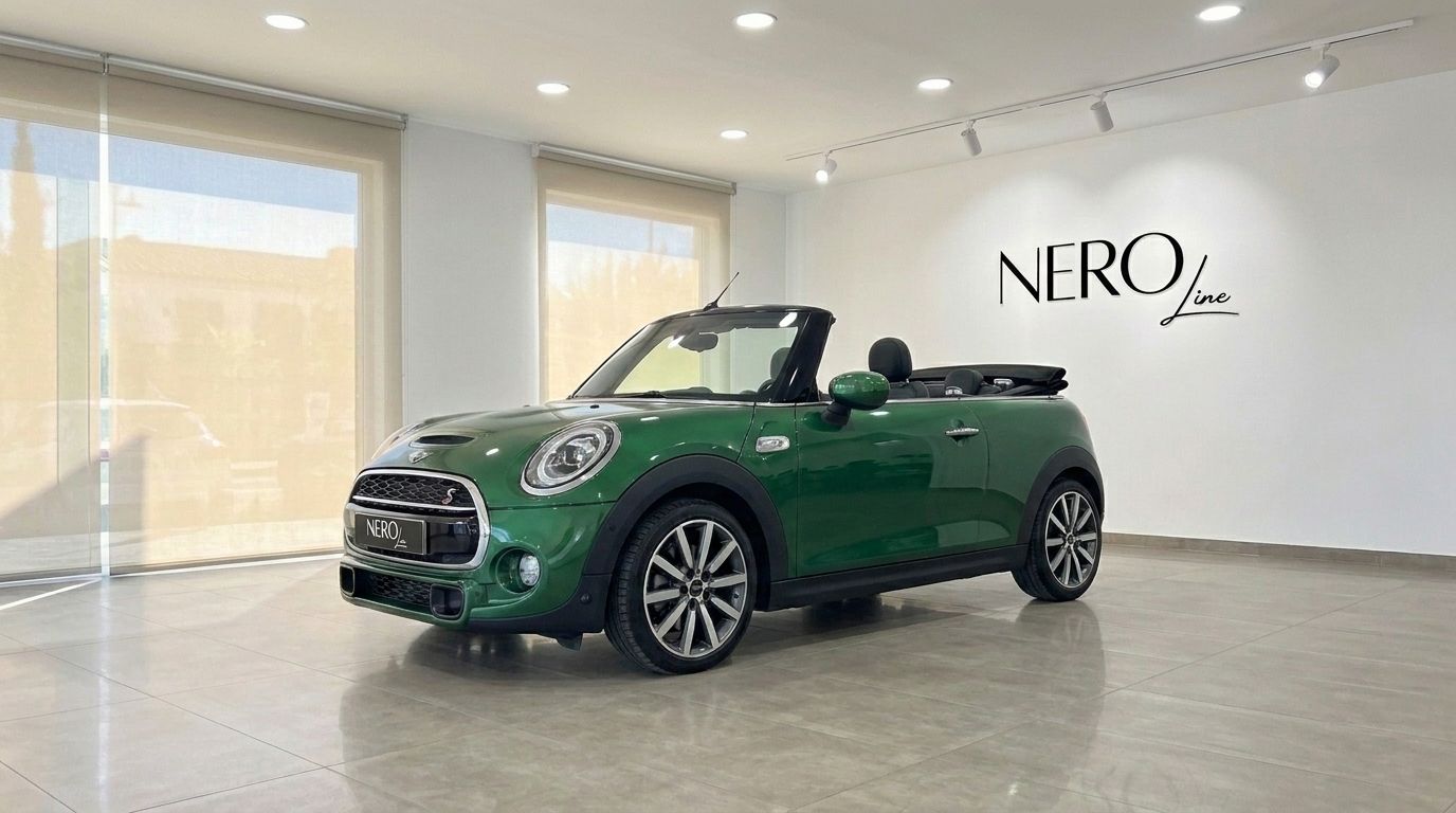 A vibrant green Mini Cooper S Cabrio, with its convertible top down, is showcased in a modern showroom in Mallorca.