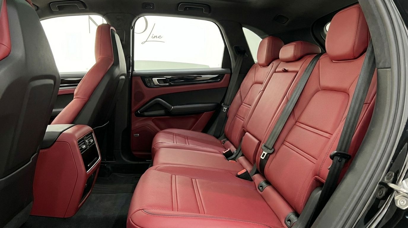 Porsche Cayenne's luxurious rear interior features vibrant red leather seats and matching door panels, available in Alicante.