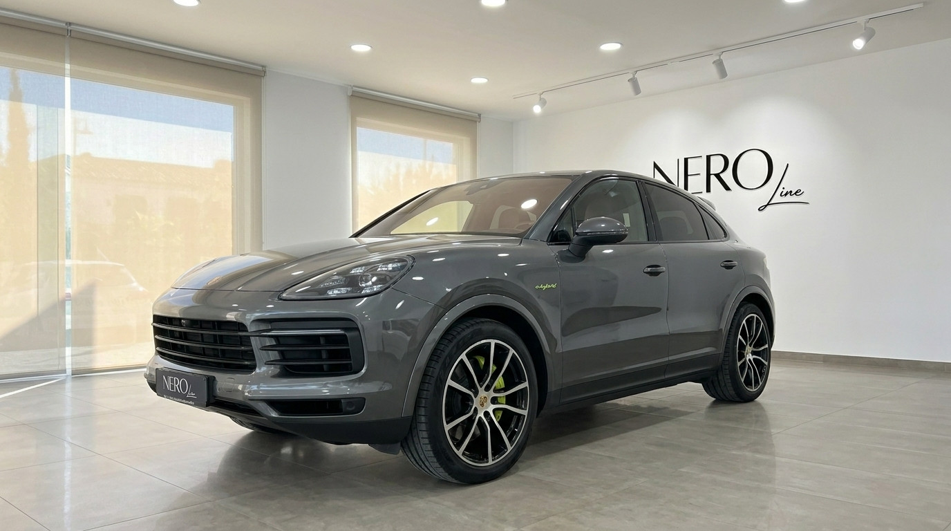 Porsche Cayenne — Front three-quarter showroom view The gloss Quarzite Grey Metallic 2022 Porsche Cayenne is showcased from a front three-quarter angle inside a modern showroom in Alicante.