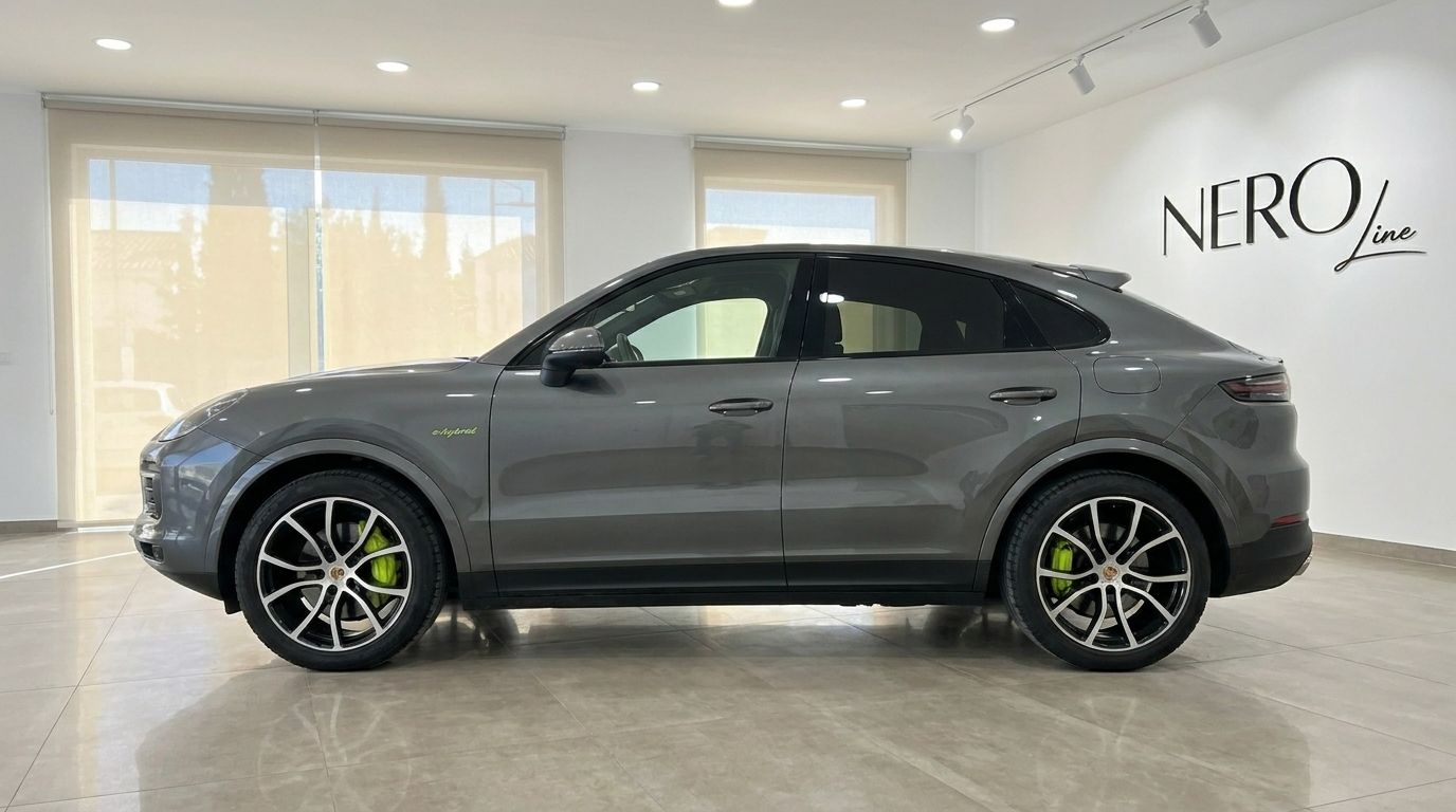 The 2022 Porsche Cayenne in gloss Quarzite Grey Metallic, showcasing its sleek side profile in Alicante.