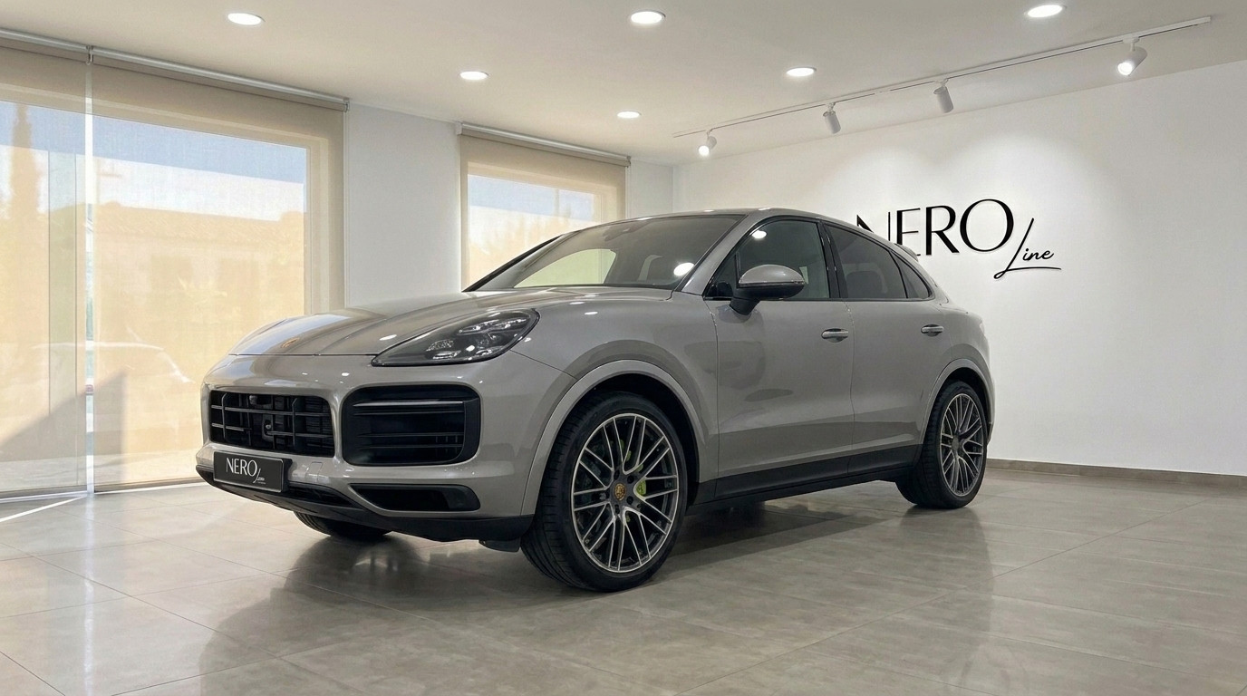 Porsche Cayenne — Luxury SUV in Mallorca The 2024 Porsche Cayenne in gloss metallic Quarzite Grey Metallic, displayed in a showroom in Mallorca.