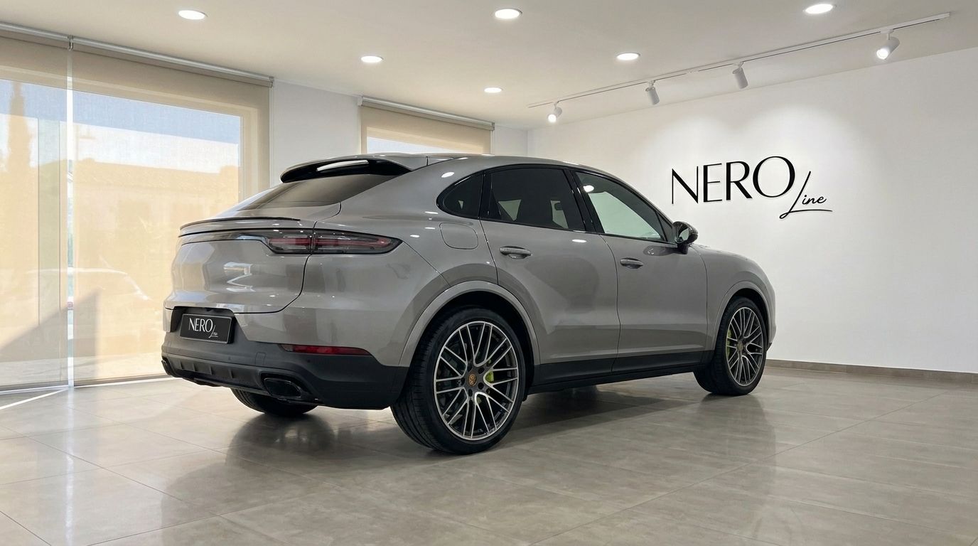The 2024 Porsche Cayenne in gloss metallic Quarzite Grey Metallic, captured from a rear three-quarter angle in Mallorca.
