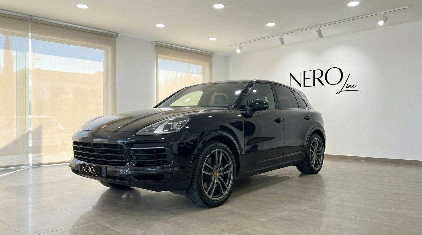Porsche Cayenne — Luxury SUV in Barcelona showroom Black 2022 Porsche Cayenne performance SUV displayed in a showroom with large windows in Barcelona.