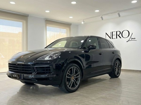 Porsche Cayenne — Luxury SUV in Barcelona showroom Black 2022 Porsche Cayenne performance SUV displayed in a showroom with large windows in Barcelona.