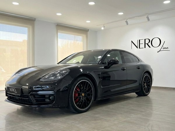Porsche Panamera GTS — Luxury Sedan in Alicante The black 2021 Porsche Panamera GTS is parked in a bright showroom in Alicante, showcasing its sleek front three-quarter view.