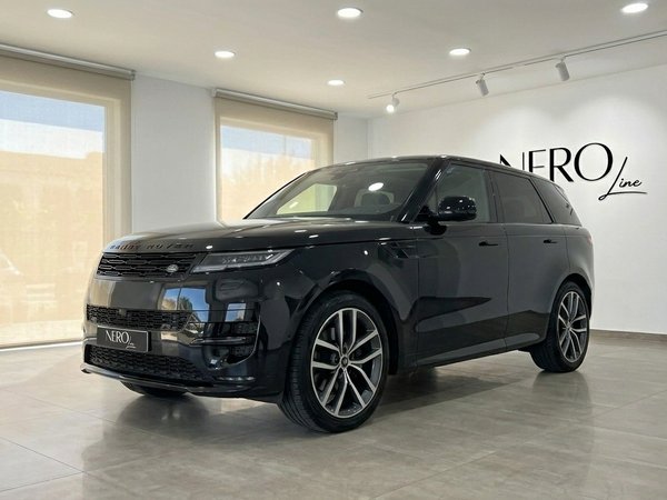Range Rover Sport — Front three-quarter view The 2023 Range Rover Sport in Gloss Black is showcased from a front three-quarter angle inside a modern showroom in Marbella.