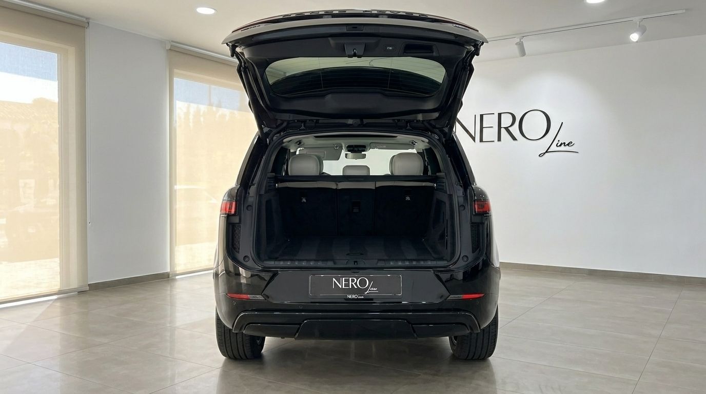 The black 2023 Range Rover Sport in Marbella, seen from the rear with its spacious trunk open, revealing the cargo area.