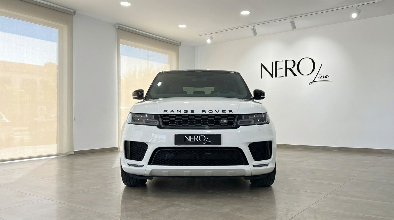 The white 2022 Range Rover Sport is prominently displayed from the front in a bright Barcelona showroom, featuring the NEROline logo.