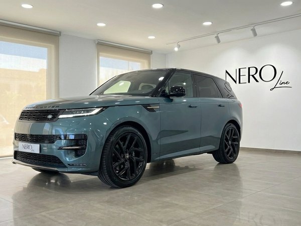 Range Rover Sport — Vista tres cuartos frontal Madrid Un Range Rover Sport verde Giola metálico está estacionado en un ángulo de tres cuartos delanteros dentro de la sala de exposición NeroLine en Madrid.