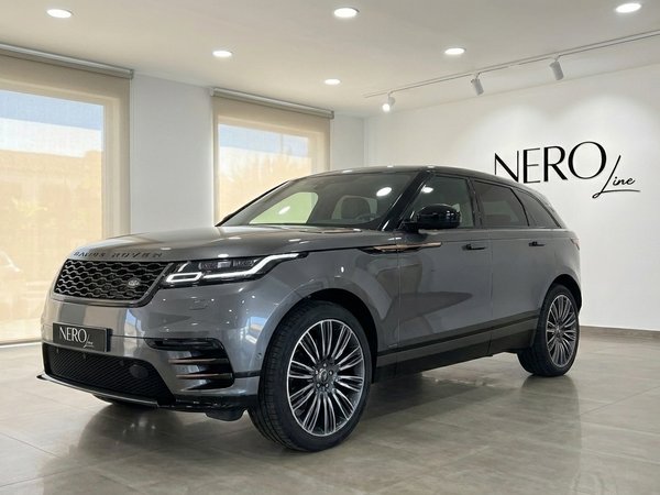 Range Rover Velar Autobiography — Marbella showroom The metallic Carpathian Grey 2024 Range Rover Velar Autobiography is showcased in a Marbella showroom, front three-quarter view.