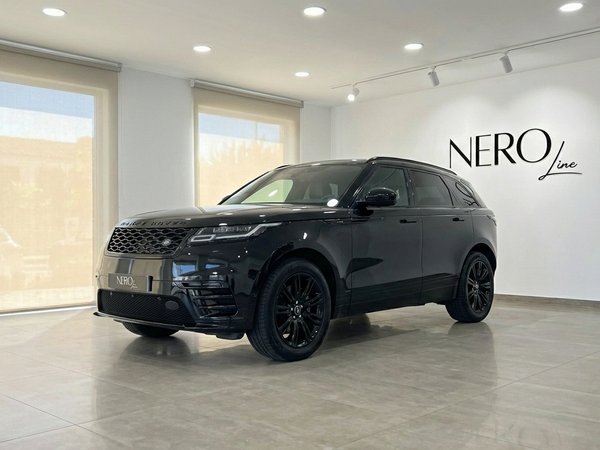 Range Rover Velar — Showroom in Alicante A metallic black 2022 Range Rover Velar is parked in a modern showroom with the NEROline logo visible in Alicante.
