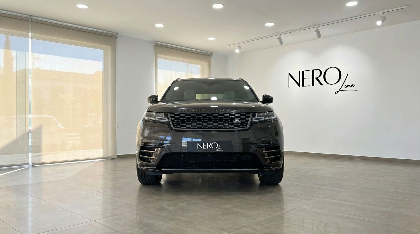 The metallic black 2022 Range Rover Velar is prominently displayed from the front in a bright Alicante showroom.
