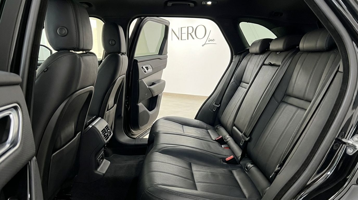 The luxurious black leather rear seats and interior of the Range Rover Velar, available for rent in Alicante.