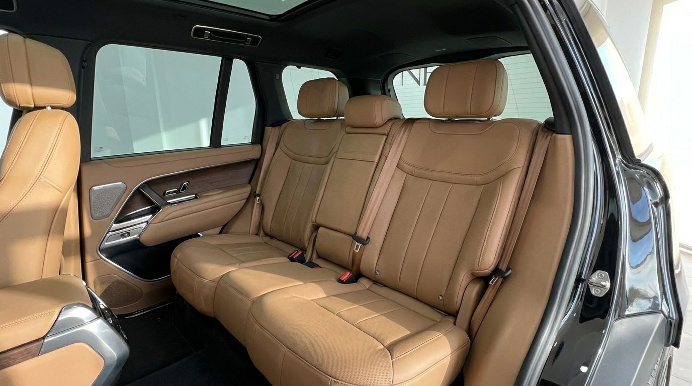 The luxurious tan leather back seats and door panel of the Range Rover Vogue HSE LWB in Marbella.