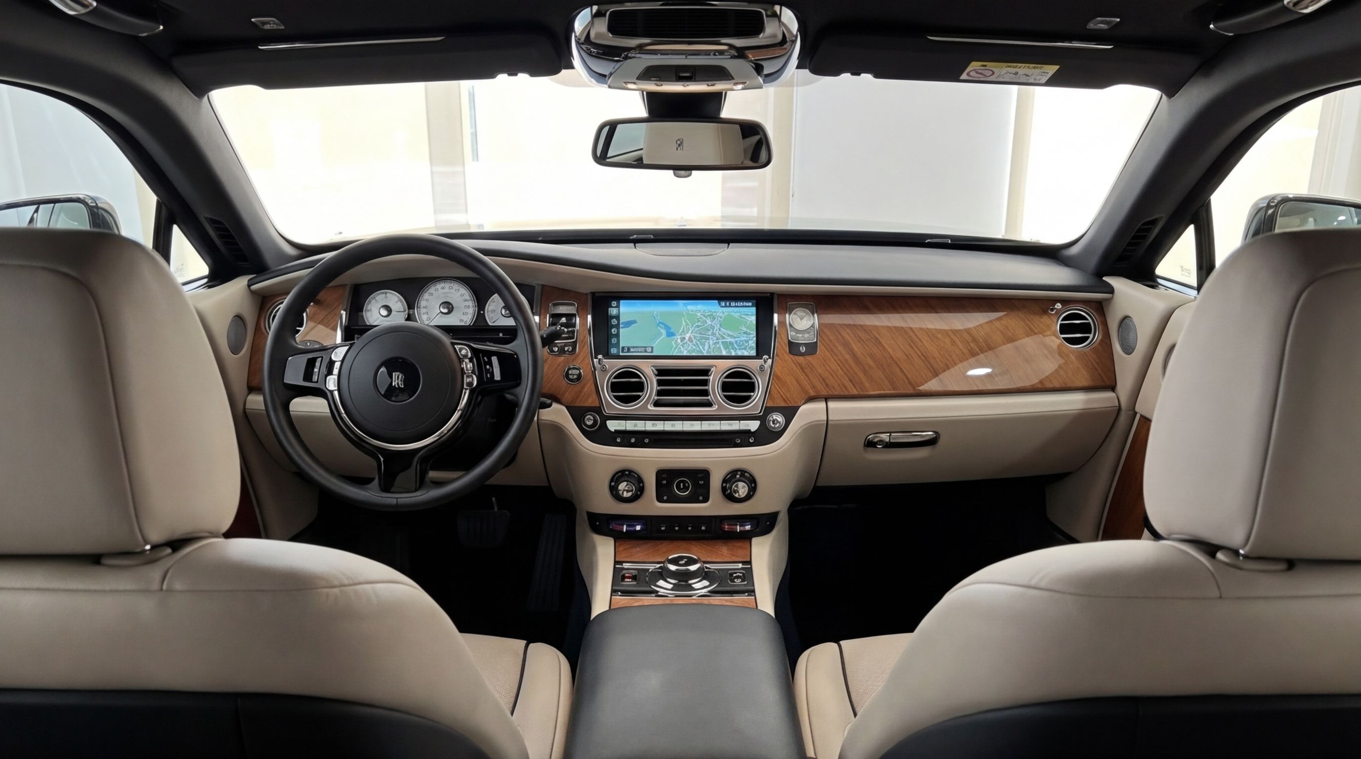 The luxurious interior of the Rolls-Royce Wraith in Malaga, featuring the dashboard, steering wheel, and front seats.