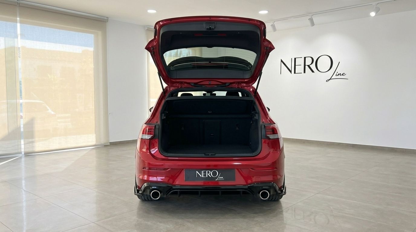 The red Volkswagen Golf GTI Clubsport is shown from the rear with its trunk open, revealing the spacious cargo area in Alicante.