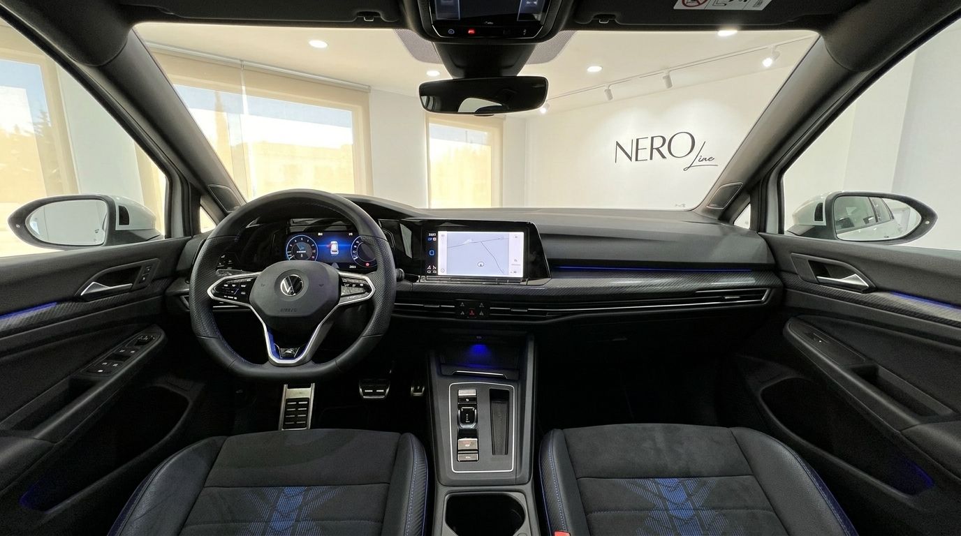 The luxurious interior and dashboard of the 2023 Volkswagen Golf R 2.0 TSI 4MOTION DSG, featuring its modern infotainment screen, available for rent in Alicante.