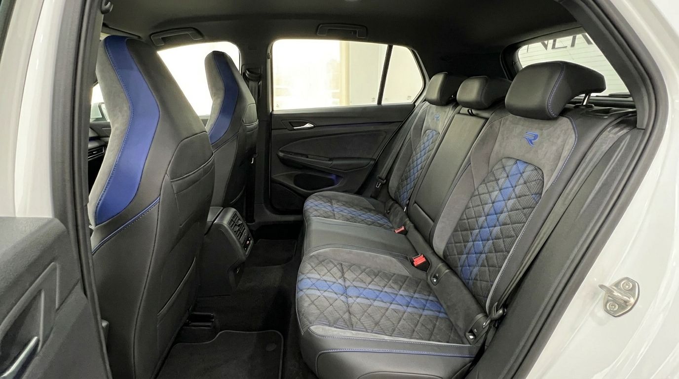The luxurious rear interior of the Volkswagen Golf R 2.0 TSI 4MOTION DSG in Alicante, featuring black and blue quilted seats.