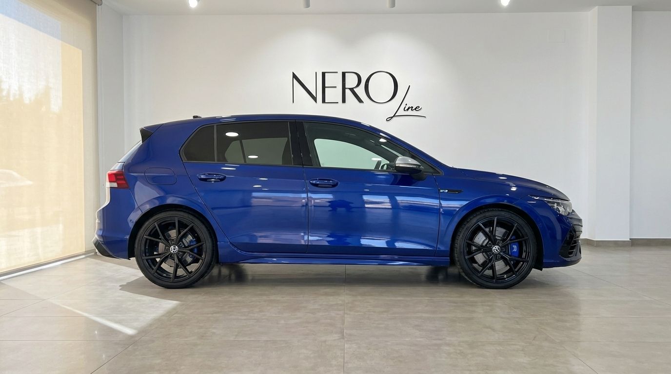The metallic blue 2023 Volkswagen Golf R is shown in a side profile view, parked indoors in Marbella.