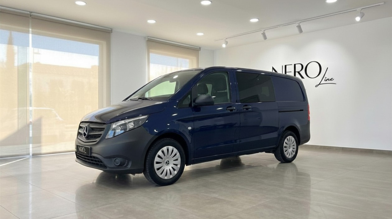 The dark blue Mercedes-Benz Vito Tourer is parked at a slight angle, showcasing its front and side profile in Alicante.
