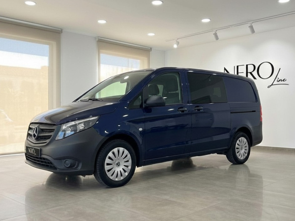 Mercedes-Benz Vito Tourer — Front side view Alicante The dark blue Mercedes-Benz Vito Tourer is parked at a slight angle, showcasing its front and side profile in Alicante.